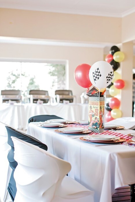 Catering chairs with black and white chair covers, plus treslte tables with white table cloths and matching runners.