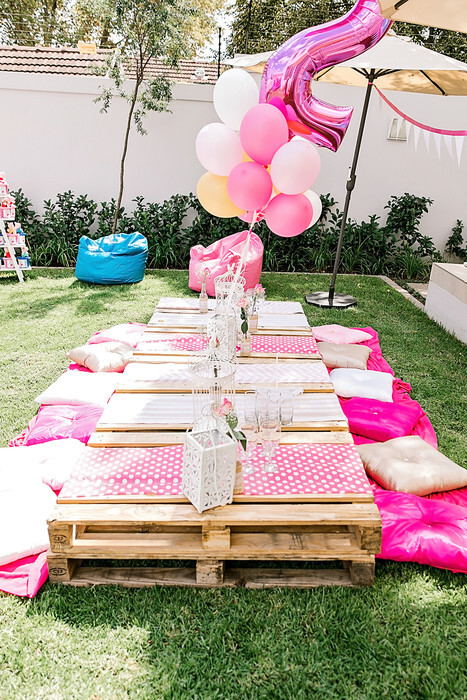 Rustic outdoor pallet setup with matching cushions and runners for hire.