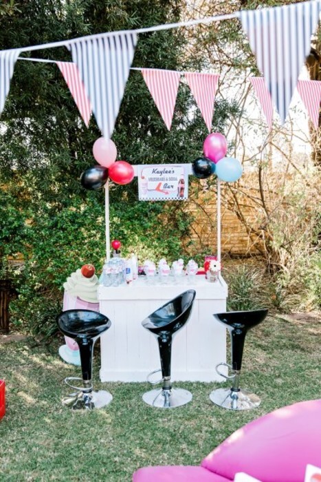 Black bar stools and wooden bar counter to hire.